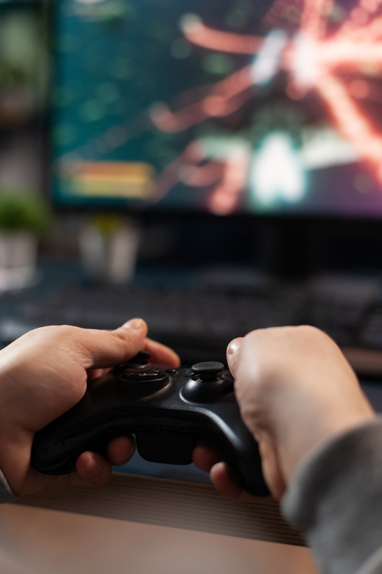 Close up of gamer holding controller to play video games